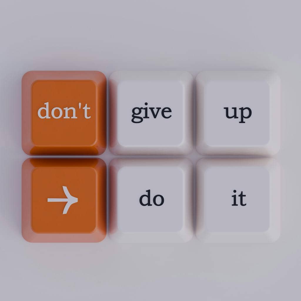 Keyboard keys spelling out 'don't give up' message, simple and inspiring.